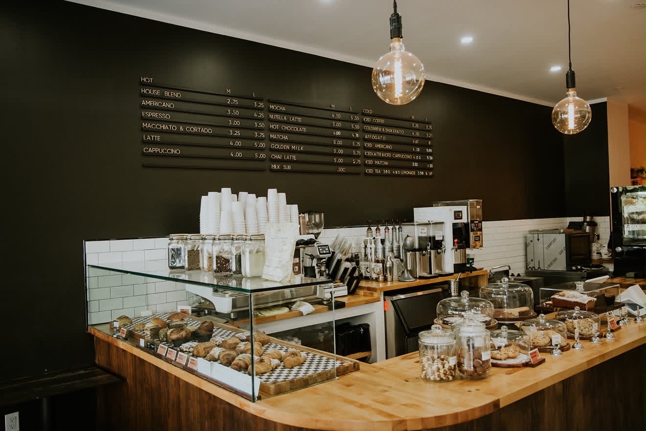 Completed cafe counter with custom millwork, subway tile and pastry display
